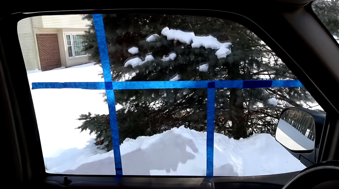 Man uses strips of painter’s tape to show how to easily defog car windows