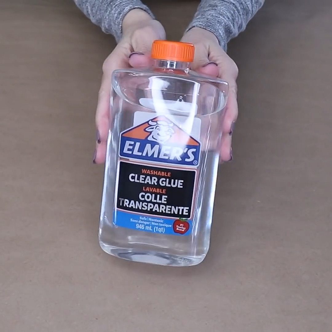 Woman fills glass vase with Elmer’s glue for beautiful home decor hack